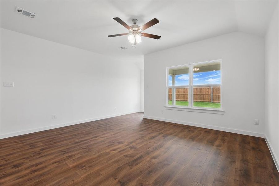Spare room featuring dark wood-type flooring and a ceiling fan Spare room featuring dark wood-type flooring and a ceiling fan
