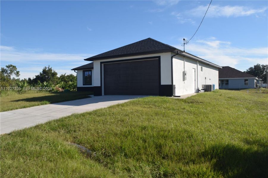 Front exterior of a new home in , Lehigh Acres, FL, highlighting curb appeal (Image 23). Front exterior of a new home in , Lehigh Acres, FL, highlighting curb appeal (Image 23).