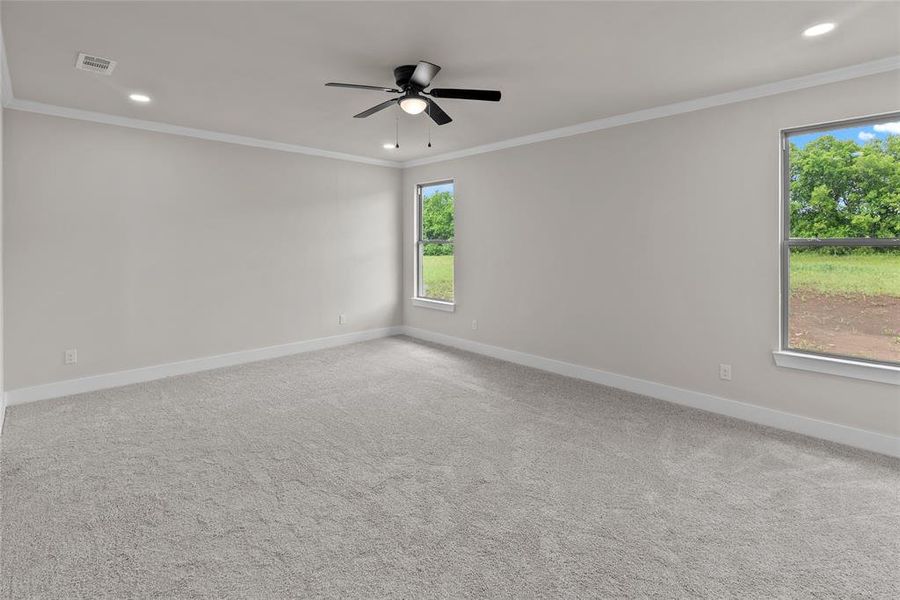 Empty room with a ceiling fan, plenty of natural light, baseboards, ornamental molding, and recessed lighting