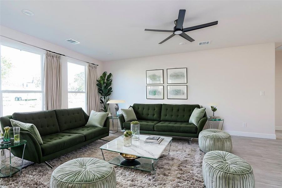 Living room featuring light wood-type flooring and ceiling fan