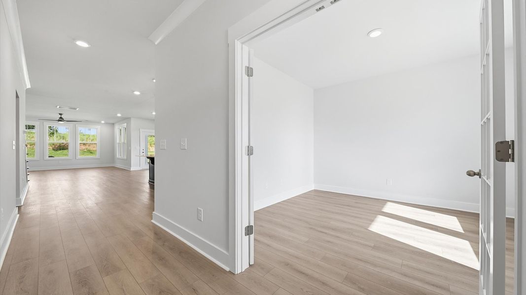Refined foyer with hardwood floors and thoughtful design for a first-rate welcome by DRB Homes