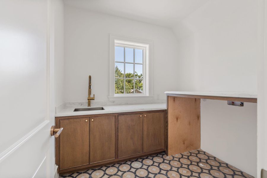 Second floor laundry includes marble countertops, cement tiles and rift cut white oak cabinetry. Second floor laundry includes marble countertops, cement tiles and rift cut white oak cabinetry.