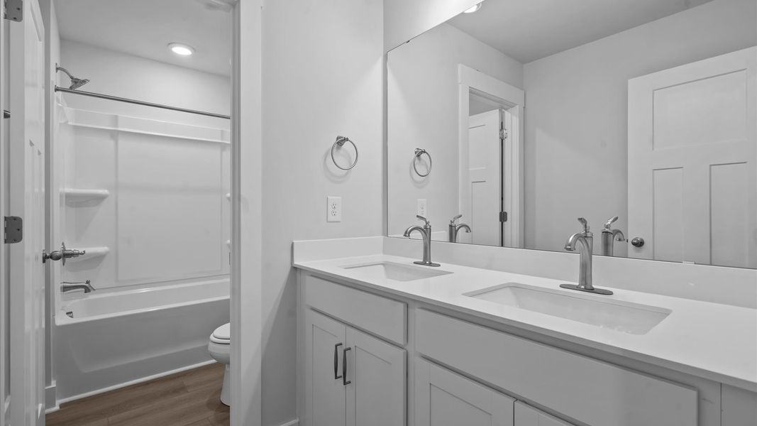 Accomplished bathroom design with sleek tile, high-quality cabinetry, and refined hardware Accomplished bathroom design with sleek tile, high-quality cabinetry, and refined hardware