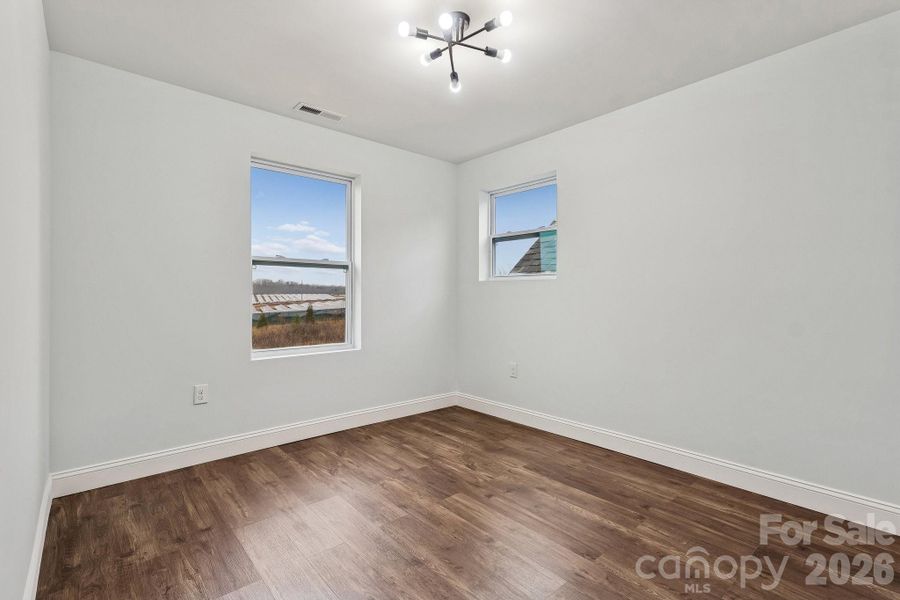 Secondary bedroom facing the rear of home with Jack and Jill full bathroom access