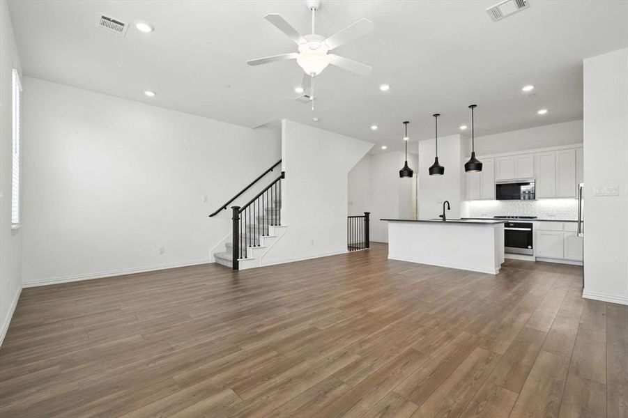 And another view of the kitchen from the living room. You can visualize the eat in kitchen at the bar area. There is enough space to put a dining table in between the island and the living room.