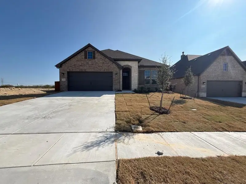 Front exterior of a new home in Waterford Park, Weatherford, TX, highlighting curb appeal (Image 1).