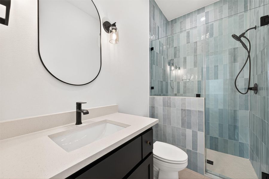 A downstairs convenient and easily accessible full guest and pool bathroom.