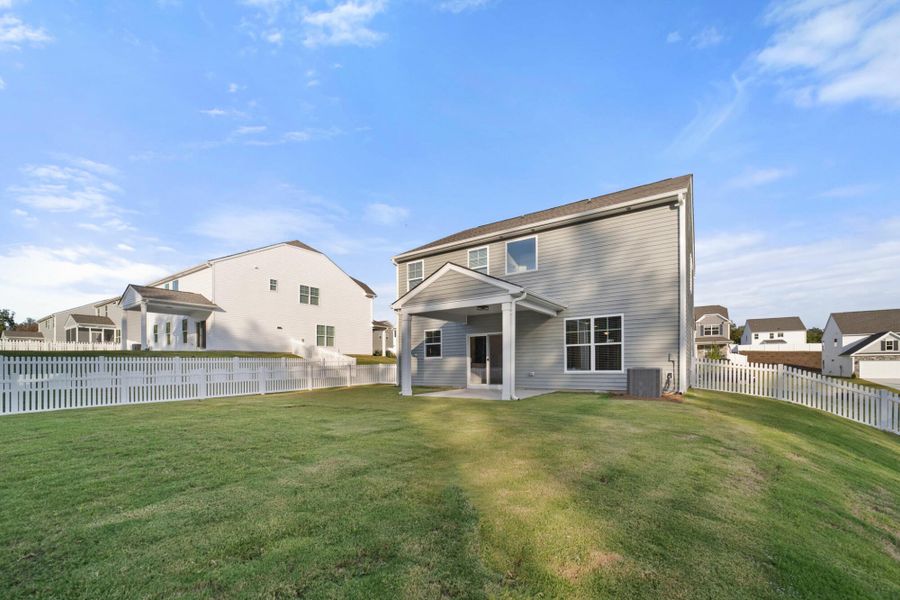 Exterior details and patio area of a home in Cottages at Piper Village, Trinity (Image 3).