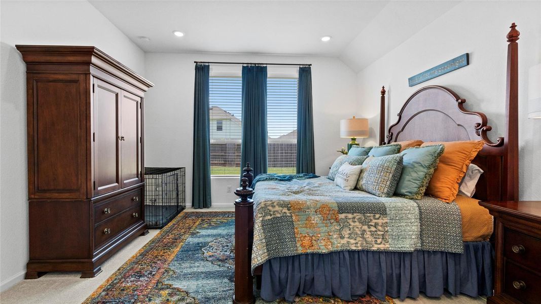 Viewed from the bathroom, this third perspective of the primary suite showcases tall windows, upgraded window treatments, high ceilings, and an inviting atmosphere. Viewed from the bathroom, this third perspective of the primary suite showcases tall windows, upgraded window treatments, high ceilings, and an inviting atmosphere.