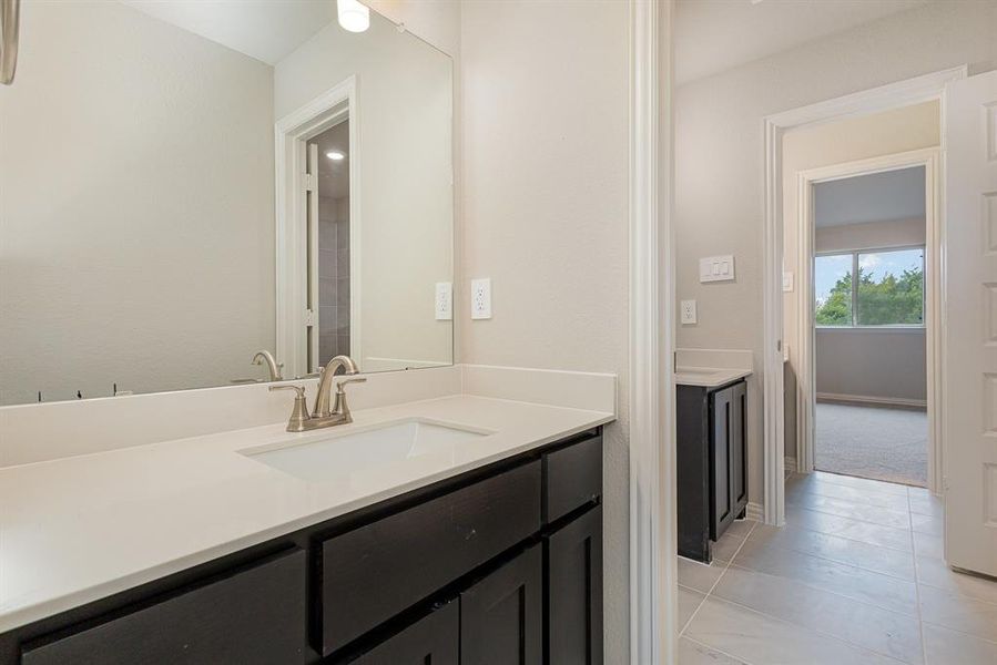 Bathroom with tile patterned flooring and vanity