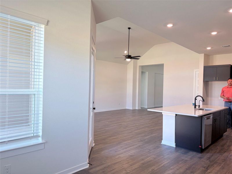 Gleaming wood-look floors anchor this airy open concept kitchen and living area design. Gleaming wood-look floors anchor this airy open concept kitchen and living area design.