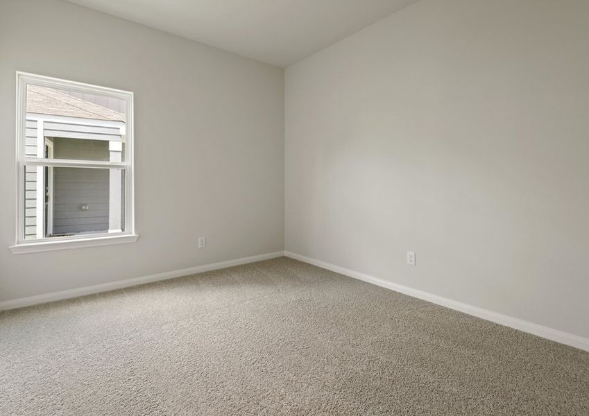 Secondary bedroom with lush carpet flooring