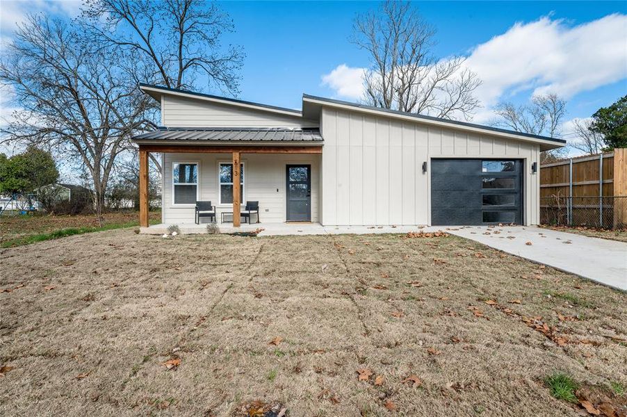 View of front of house with a garage and covered porch