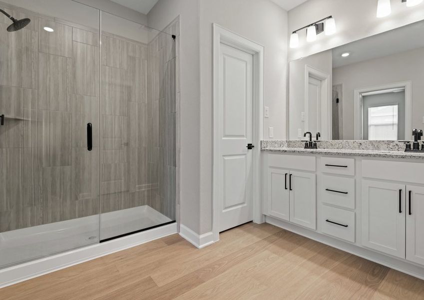 Spacious master bathroom with a dual sink vanity and step-in shower Spacious master bathroom with a dual sink vanity and step-in shower