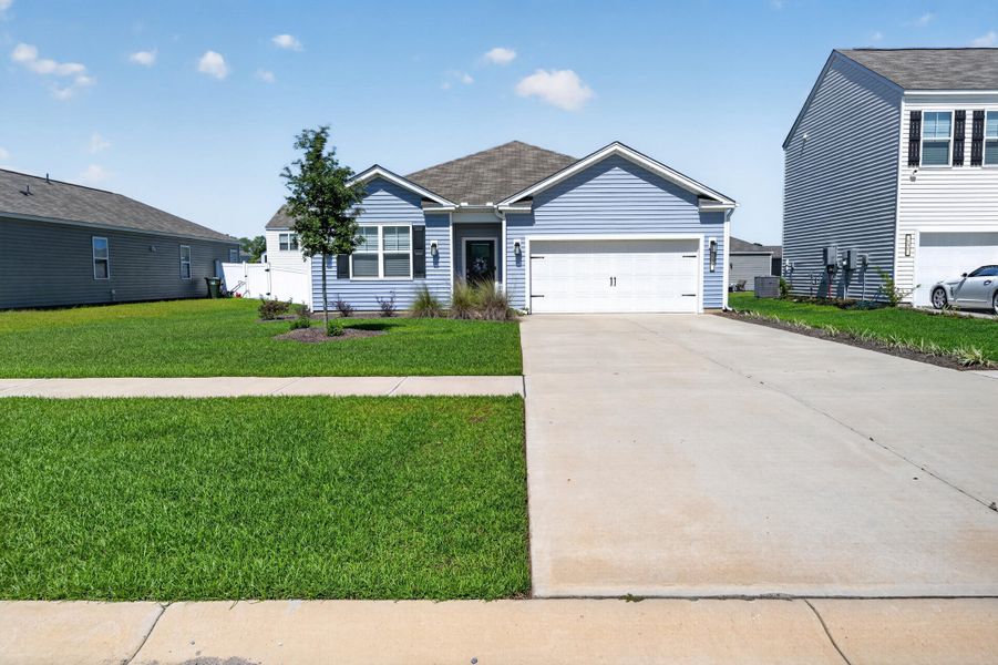 Front exterior of a new home in Carolina Groves, Moncks Corner, SC, highlighting curb appeal (Image 20).