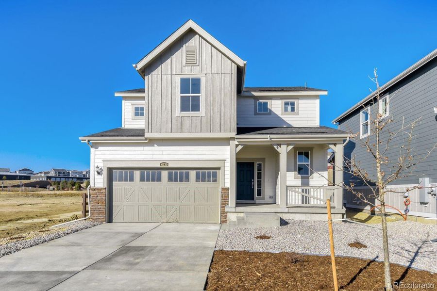Front exterior of a new home in Newlin Crossing, Parker, CO, highlighting curb appeal (Image 1). Front exterior of a new home in Newlin Crossing, Parker, CO, highlighting curb appeal (Image 1).