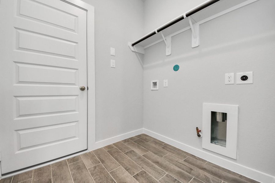 A perfect blend of functionality and comfort. Capture the essence of easy living with a first-floor laundry room, thoughtfully equipped with shelving for effortless organization. Both electric and gas connections available. A perfect blend of functionality and comfort. Capture the essence of easy living with a first-floor laundry room, thoughtfully equipped with shelving for effortless organization. Both electric and gas connections available.