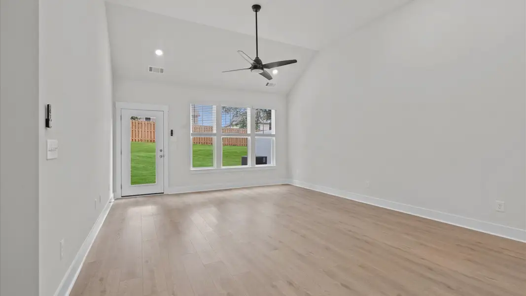 Two story ceiling family room with beautiful hardwood flooring in two story townhome at Aspen Ridge by DRB Homes in Lyman, SC Two story ceiling family room with beautiful hardwood flooring in two story townhome at Aspen Ridge by DRB Homes in Lyman, SC