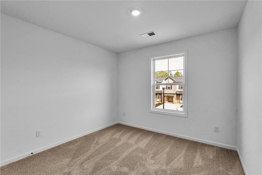 This bright bedroom offers a neutral canvas, ready