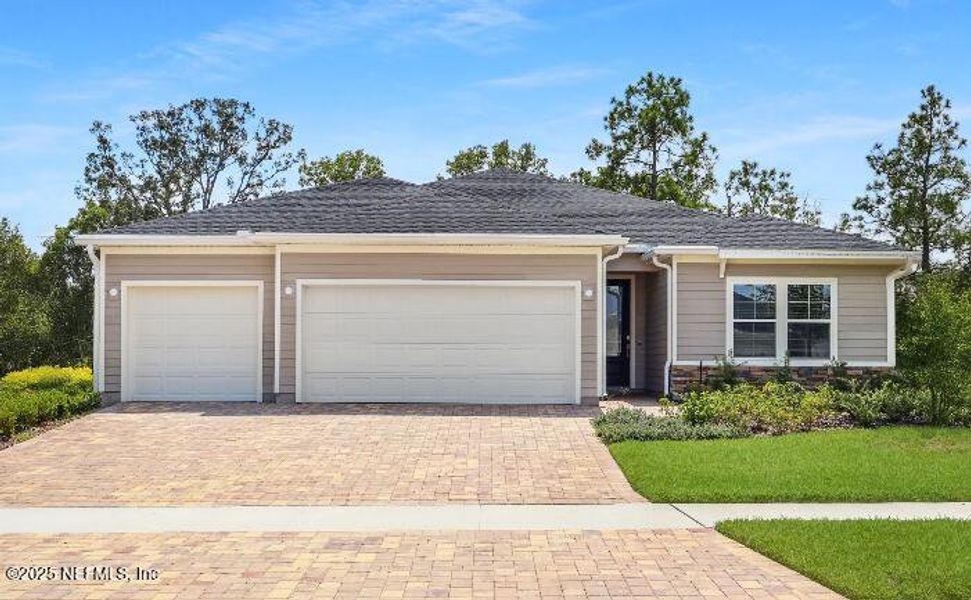 Front exterior of a new home in Tributary: Tributary Royal Collection, Yulee, FL, highlighting curb appeal (Image 1). Front exterior of a new home in Tributary: Tributary Royal Collection, Yulee, FL, highlighting curb appeal (Image 1).