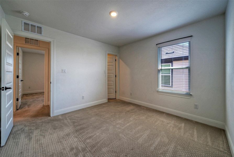 Soft carpeting and a large window define this comfortable secondary bedroom. Soft carpeting and a large window define this comfortable secondary bedroom.
