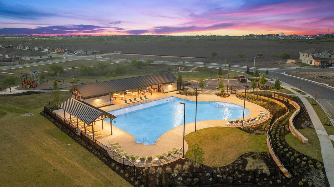 Pool at dusk with a community pool and a patio Pool at dusk with a community pool and a patio