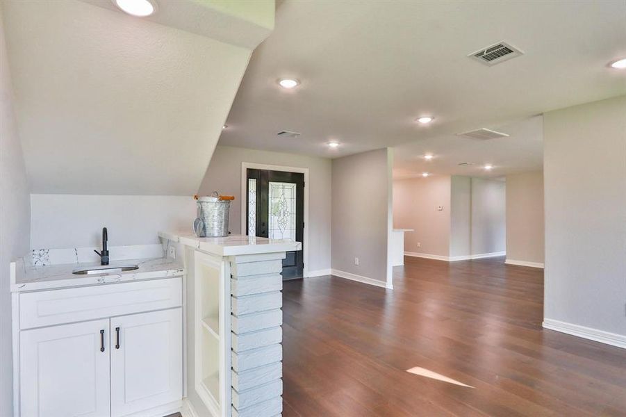 Modern Lifestyle With Classic Design. Convenient wet bar tucked under the stairs is great for entertaining around the fireplace.