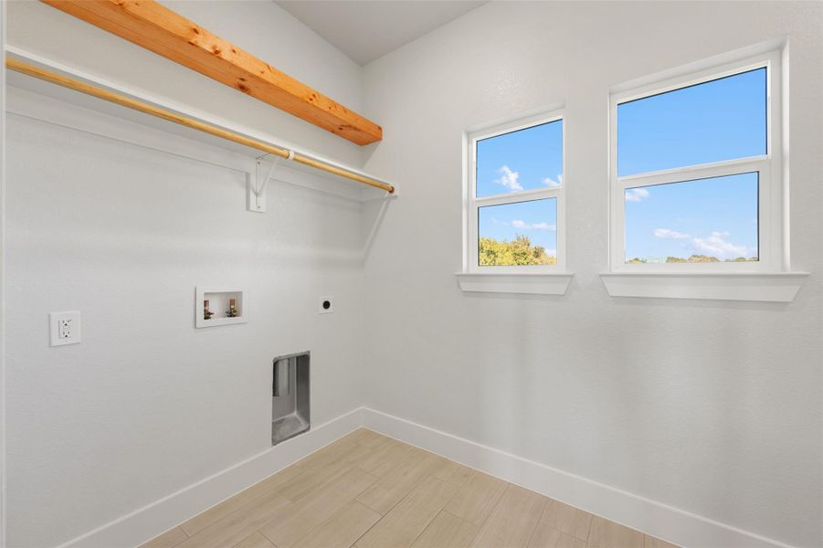 Laundry room featuring washer hookup, light wood finished floors, and hookup for an electric dryer