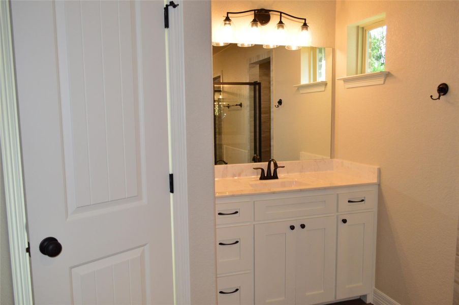 Bathroom featuring a shower stall and vanity