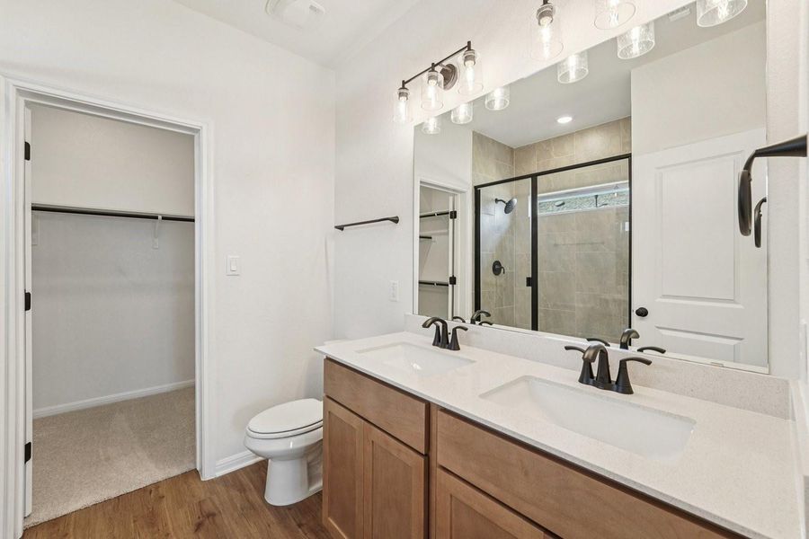 Double vanities and a spacious walk-in shower elevate this well-appointed bathroom. Double vanities and a spacious walk-in shower elevate this well-appointed bathroom.