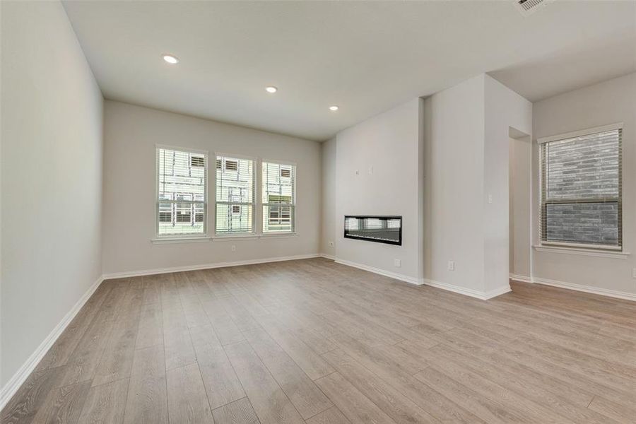 Unfurnished living room with light hardwood / wood-style floors