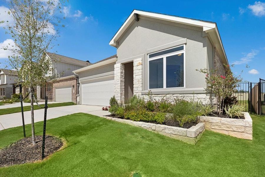 Front exterior of a new home in Santa Rita Ranch, Liberty Hill, TX, highlighting curb appeal (Image 20). Front exterior of a new home in Santa Rita Ranch, Liberty Hill, TX, highlighting curb appeal (Image 20).