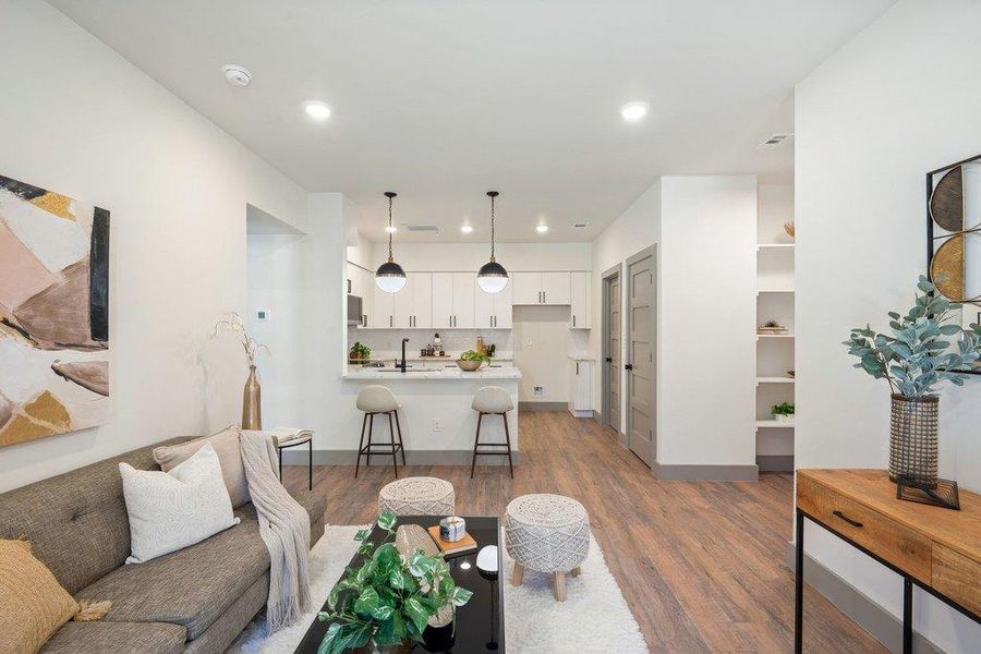 Living area featuring light wood-style flooring and recessed lighting