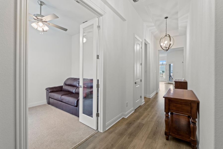 The welcoming foyer features designer pendant lighting and high ceilings that lead you past a versatile dining/flex space.