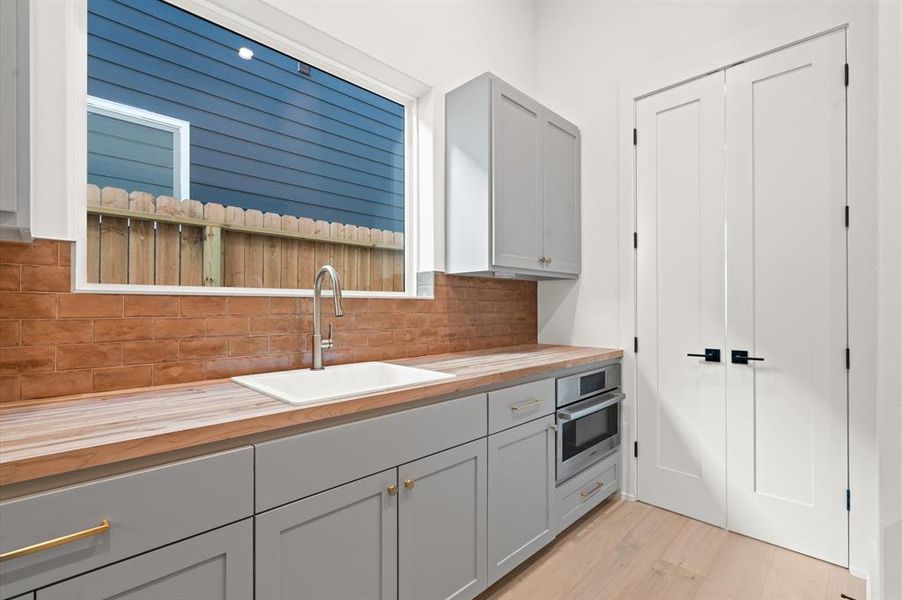 Interior view of butler's pantry with built in microwave. Previous TOMO Homes project.