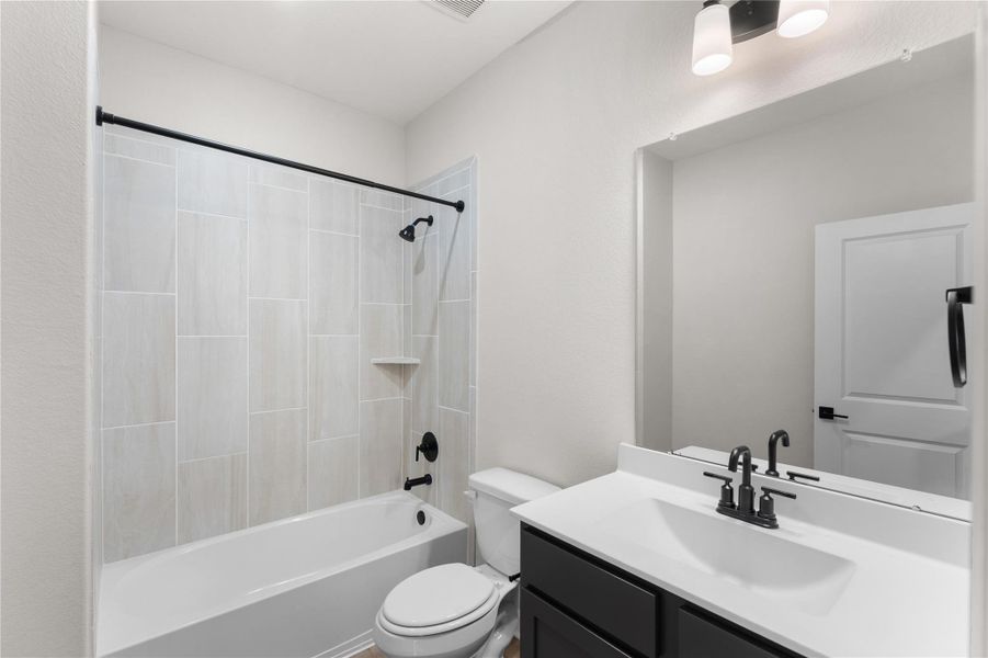 Stylish secondary bathroom with modern finishes, a tub/shower combination, sleek fixtures, and a spacious vanity. Designed for both comfort and convenience Stylish secondary bathroom with modern finishes, a tub/shower combination, sleek fixtures, and a spacious vanity. Designed for both comfort and convenience