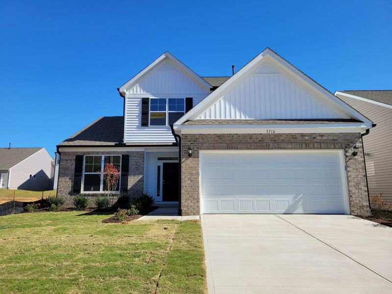 Front exterior of a new home in 1158 Place, Wilson, NC, highlighting curb appeal (Image 1).