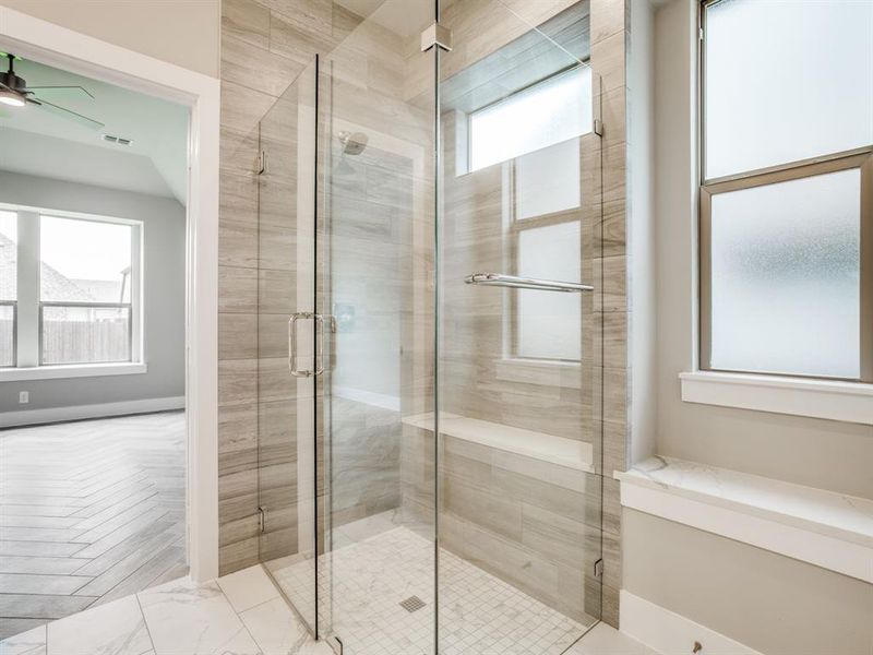 Full bathroom featuring a shower stall, a ceiling fan, and visible vents