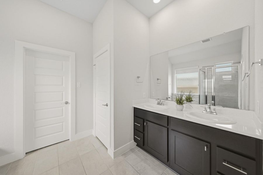 Spa inspired primary bath with dual sinks, soaking tub, and separate shower. Spa inspired primary bath with dual sinks, soaking tub, and separate shower.