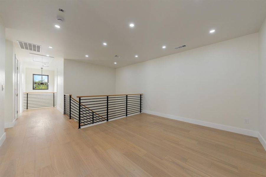 recessed lighting, and light wood-style floors