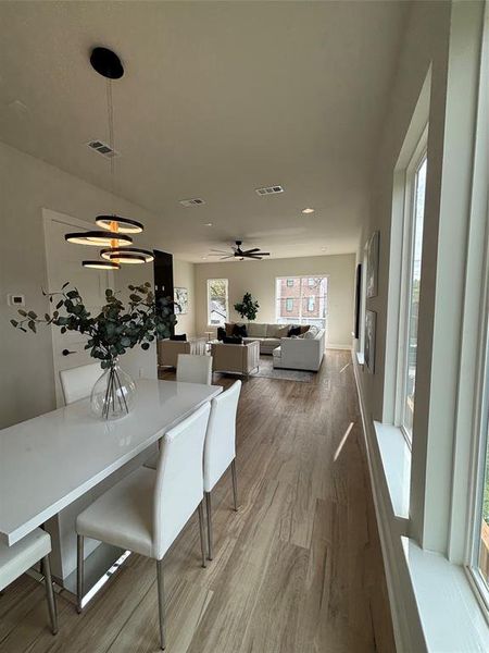 Dining space featuring light wood finished floors and a ceiling fan