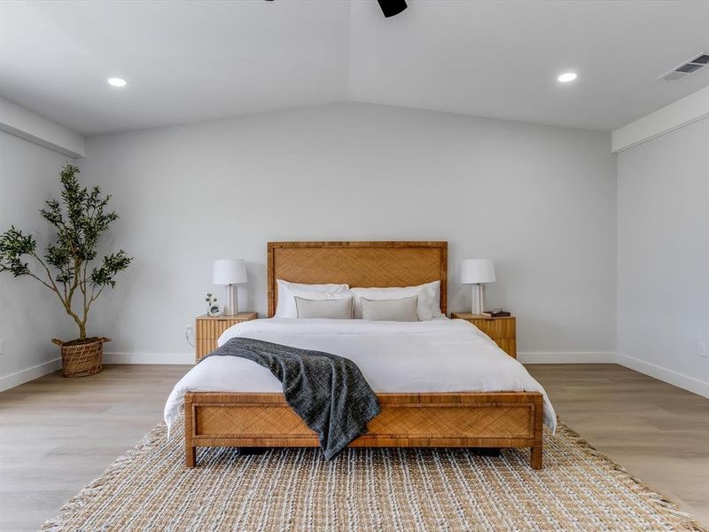 Massive and chic upstairs primarybedroom. Spacious room featuring a vaulted ceiling and recessed lighting Massive and chic upstairs primarybedroom. Spacious room featuring a vaulted ceiling and recessed lighting