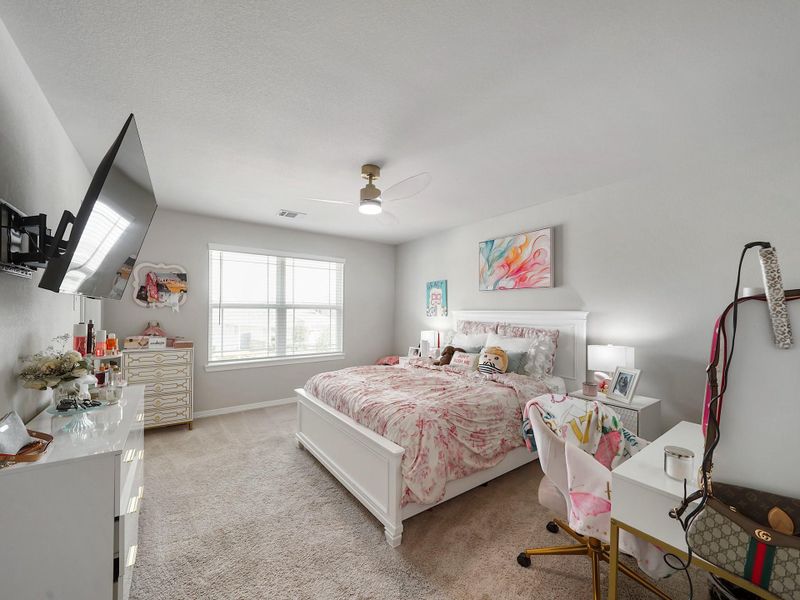 A generously sized secondary bedroom with natural light and ample space to create a comfortable and personalized retreat.