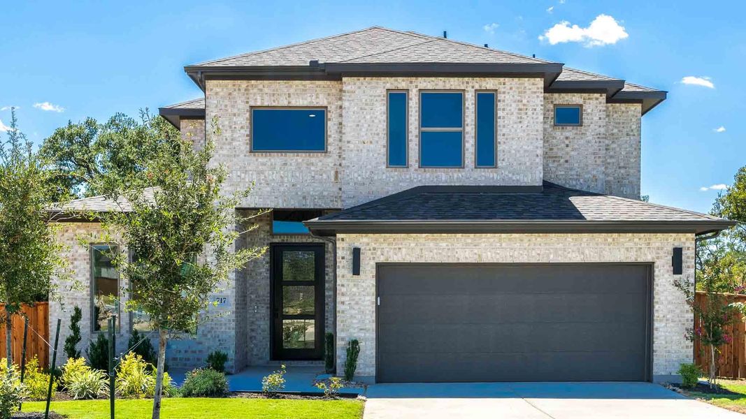 Front exterior of a new home in Parmer Ranch, Georgetown, TX, highlighting curb appeal (Image 1). Front exterior of a new home in Parmer Ranch, Georgetown, TX, highlighting curb appeal (Image 1).