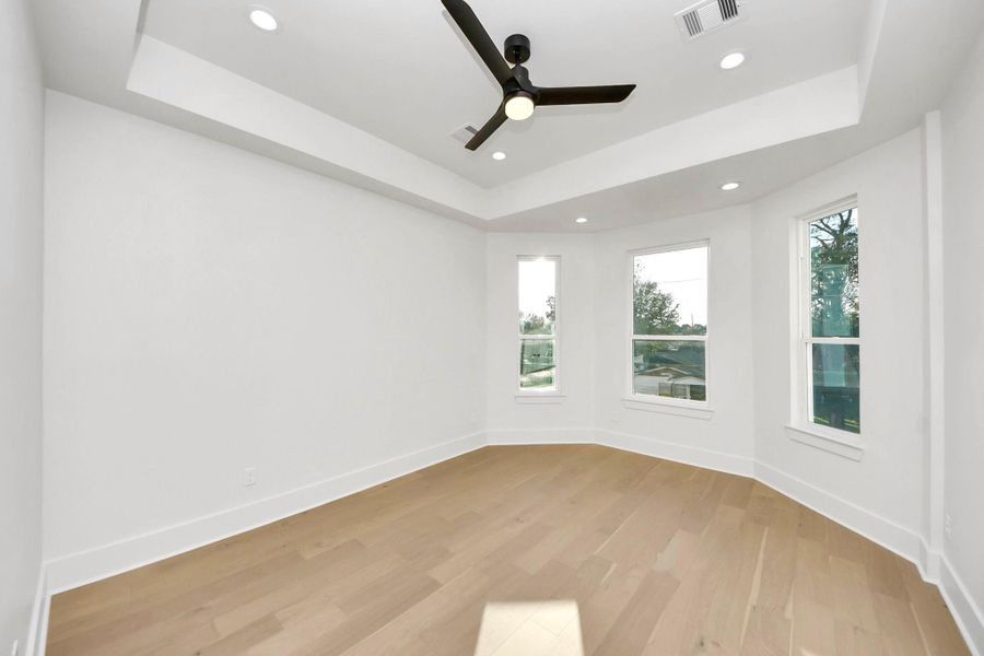 Your primary suite oasis is filled with ample natural light, creating a serene space to unwind. The room features an expanded ceiling fan and multiple ceiling lights, adding both comfort and ambiance. Your primary suite oasis is filled with ample natural light, creating a serene space to unwind. The room features an expanded ceiling fan and multiple ceiling lights, adding both comfort and ambiance.