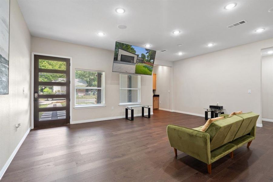 Sitting room with dark wood finished floors and recessed lighting Sitting room with dark wood finished floors and recessed lighting