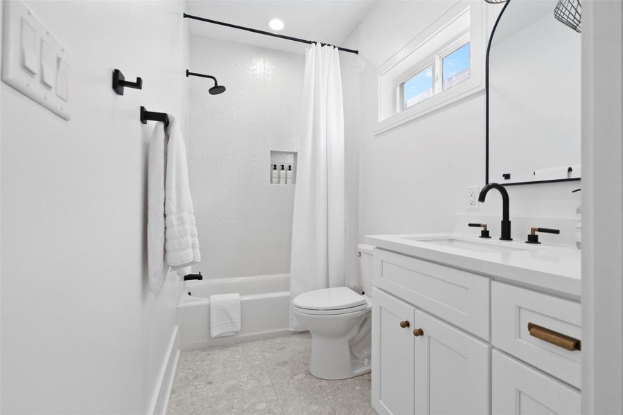 Connected to the family bunk bedroom, this second-floor bathroom combines comfort and convenience with a stylish shower-and-tub combo enclosed by soft curtains, a modern toilet, and a spacious vanity featuring built-in drawers and cabinetry. Natural light and thoughtful design touches make it a polished, coastal-inspired retreat for guests or kids alike. Connected to the family bunk bedroom, this second-floor bathroom combines comfort and convenience with a stylish shower-and-tub combo enclosed by soft curtains, a modern toilet, and a spacious vanity featuring built-in drawers and cabinetry. Natural light and thoughtful design touches make it a polished, coastal-inspired retreat for guests or kids alike.