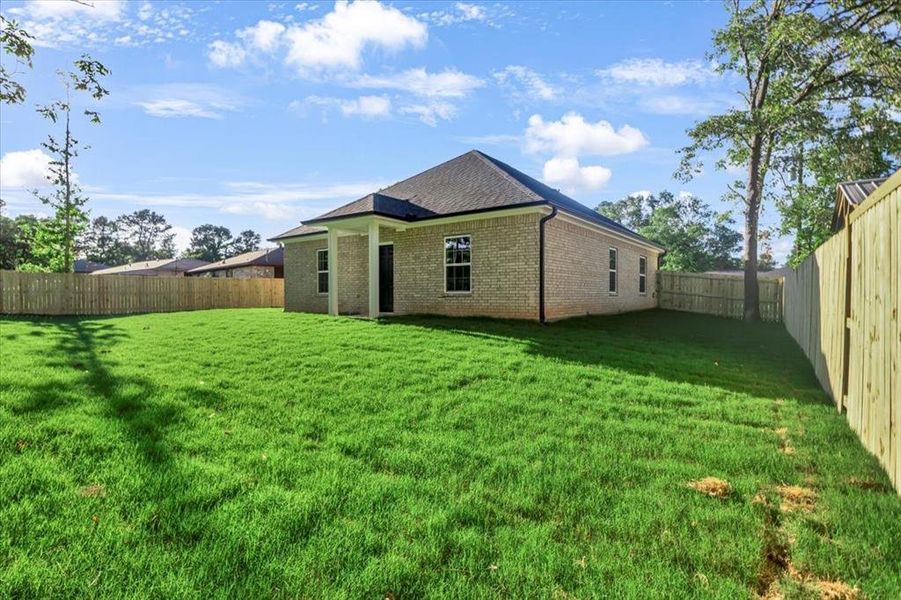 Rear view of property featuring brick siding