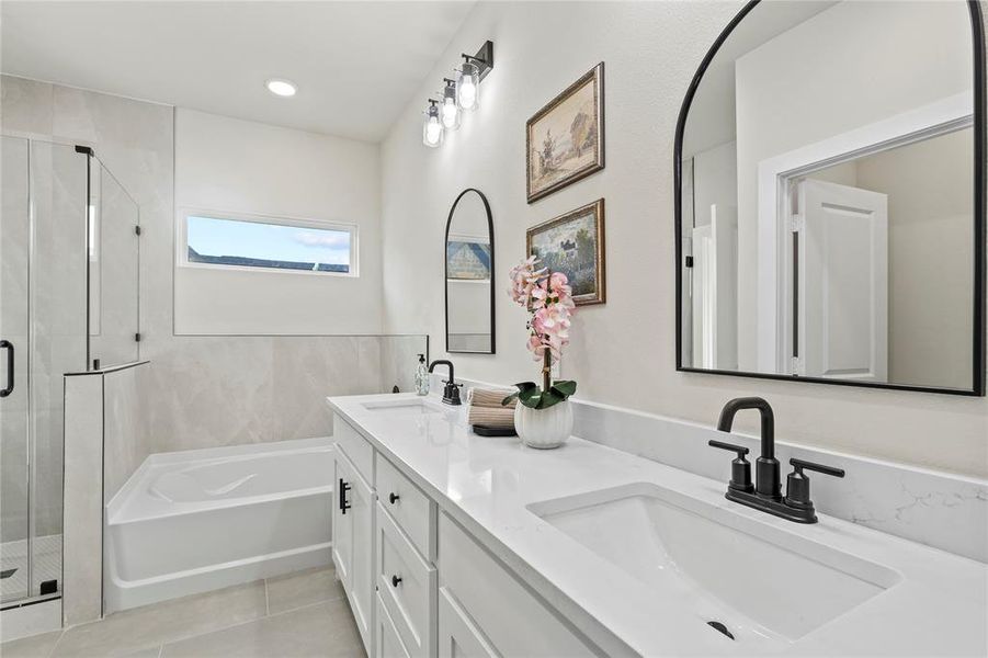 Full bath with a bath, a stall shower, double vanity, light tile patterned floors, and recessed lighting Full bath with a bath, a stall shower, double vanity, light tile patterned floors, and recessed lighting