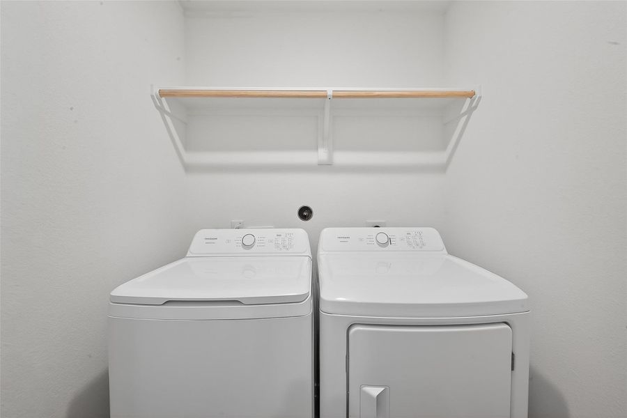 The laundry room is conveniently located near the primary suite.